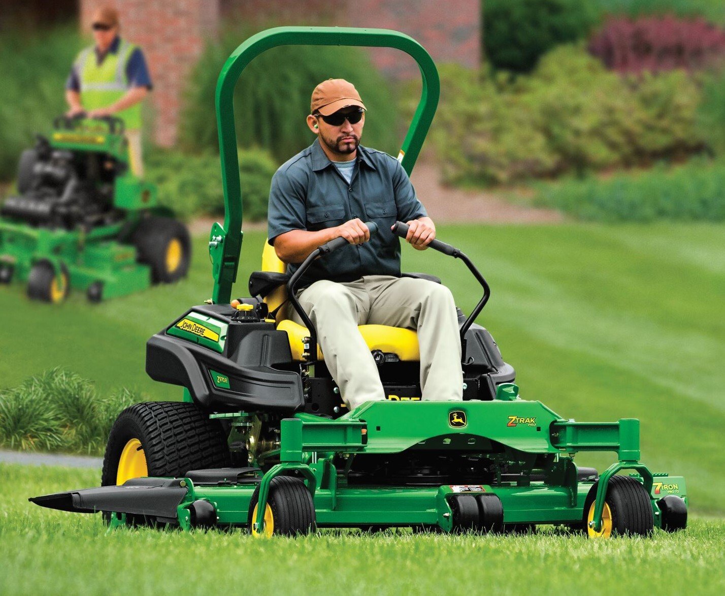 Image Courtesy of John Deer, lawn service provider riding a green zero tury mower.
